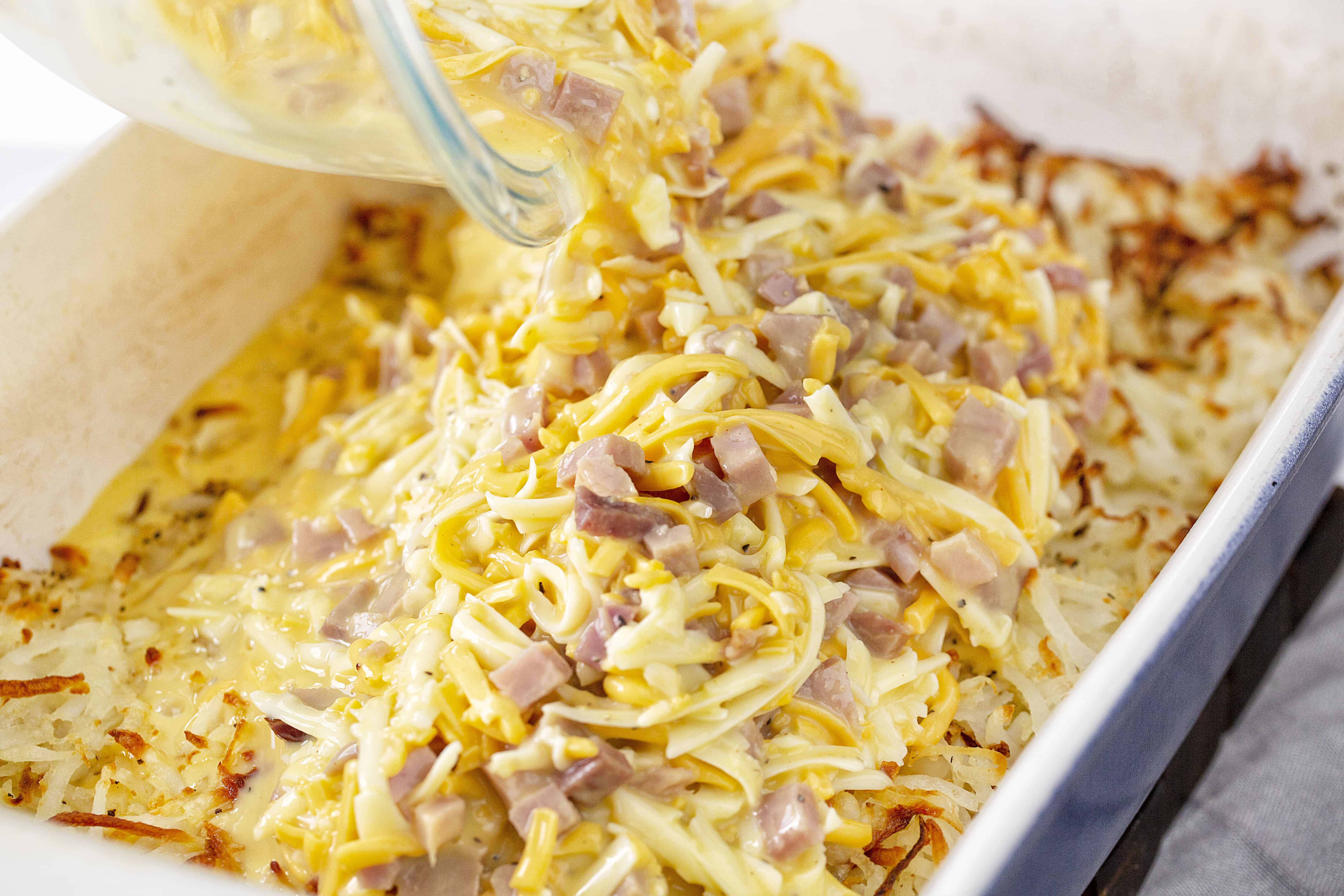 This ooey gooey cheesy ham and crisp hashbrown casserole is going to be a new favorite way to serve breakfast! casserole, ham casserole, cheesy casserole, breakfast casserole, breakfast, ham and cheese breakfast, iambaker Ham and Cheese Breakfast Casserole