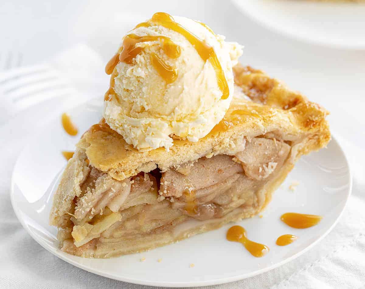 Classic Apple Pie is a traditional apple pie made with a no-fail, homemade pie crust that is filled and baked with fresh apples. Apple Pie, Pie Crust, Thanksgiving, Dessert, Apple Dessert, How to Make Mile High Apple Pie, What Apples for Apple Pie, Easy Apple Pie, i am baker,iambaker Slice of Apple Pie on Plate with Ice Cream