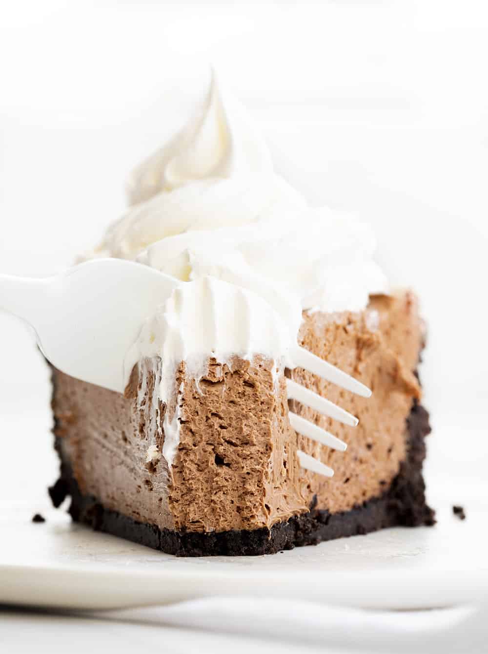 Baileys Chocolate Cream Pie is an adult dessert made with an Oreo cookie crust that is filled with a chocolate cheesecake flavored with Baileys Irish Cream. Baileys Pie Recipes, Baileys Chocolate Cream Pie, Chocolate Pie, No Bake Dessert, Oreo Pie Crust, Pie Recipes, Dessert, i am baker, iambaker, chocolate Fork Taking Bite of Bailey's Chocolate Cream Pie