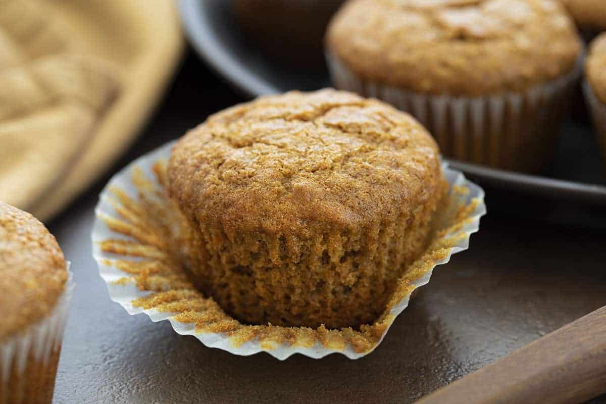 Bran Muffins are moist muffins that can be made with bran cereal or wheat bran and are a wonderful source of fiber to keep you feeling full all morning! Bran Muffin Recipe, Bran Muffins, Easy Bran Muffins, Breakfast, Muffin Recipes, Soft Bran Muffins, Moist Bran Muffins, recipes, i am baker, iambaker Bran Muffin with Wrapper Pulled Off