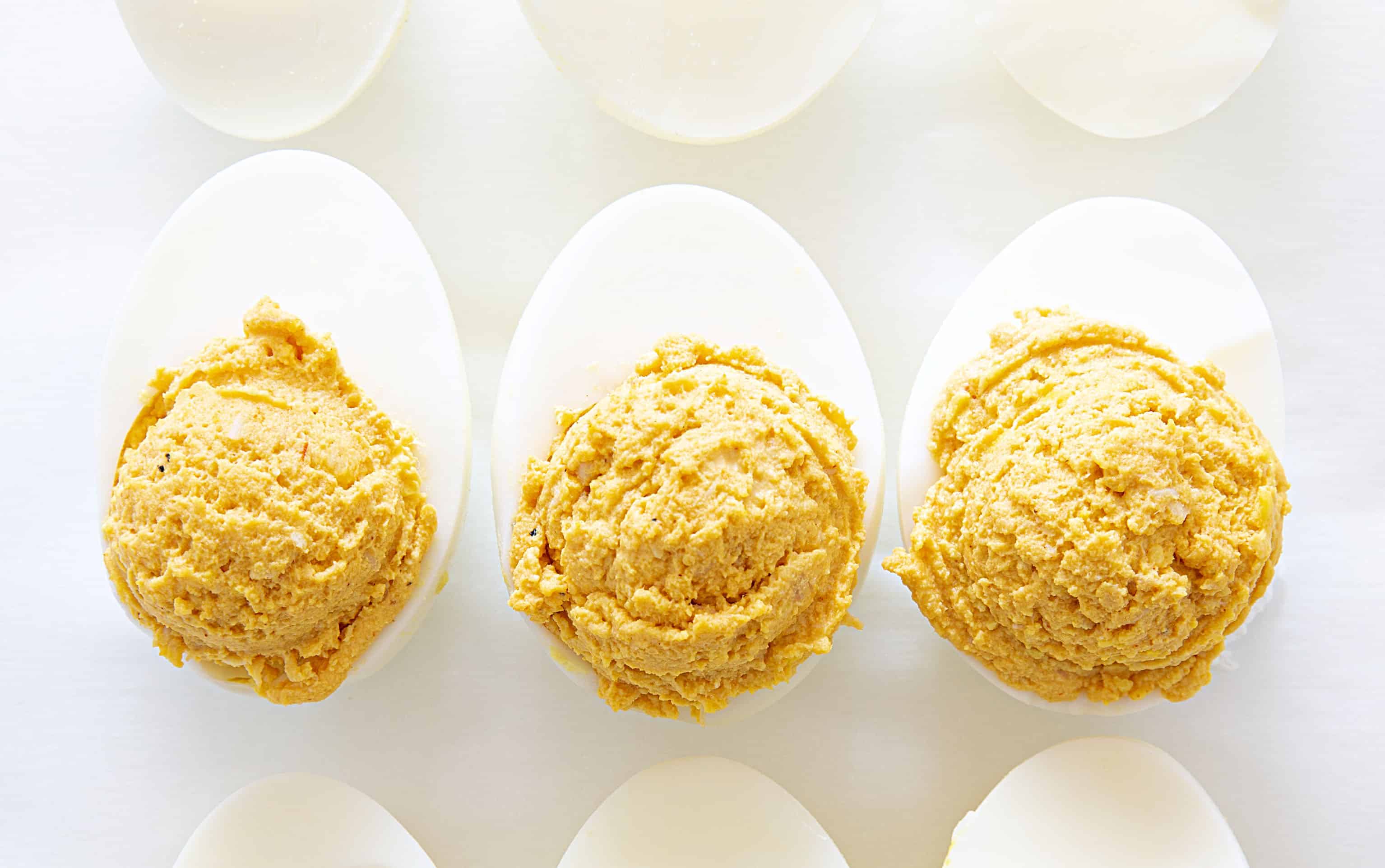 Deviled eggs with a buffalo chicken kick will be your new game day favorite! #deviledeggs #buffalochicken #buffalochickendeviledeggs #homemaderanchdressing #superbowlappetizer #appetizer #gamedayappetizer #hardboiledeggs #eggs Hard Boiled Eggs Filled with Buffalo Chicken Filling