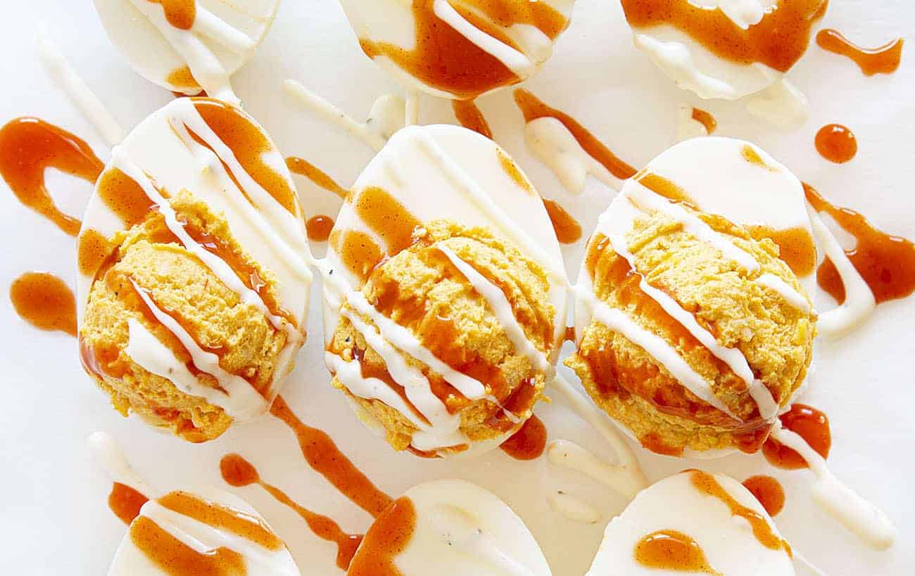 Deviled eggs with a buffalo chicken kick will be your new game day favorite! deviled eggs, buffalo chicken, buffalo chicken deviled eggs, homemade ranch dressing, superbowl appetizer, appetizer, game day appetizer, hard boiled eggs, eggs Buffalo Chicken Deviled Eggs Covered with Hot Sauce and Ranch Dressing