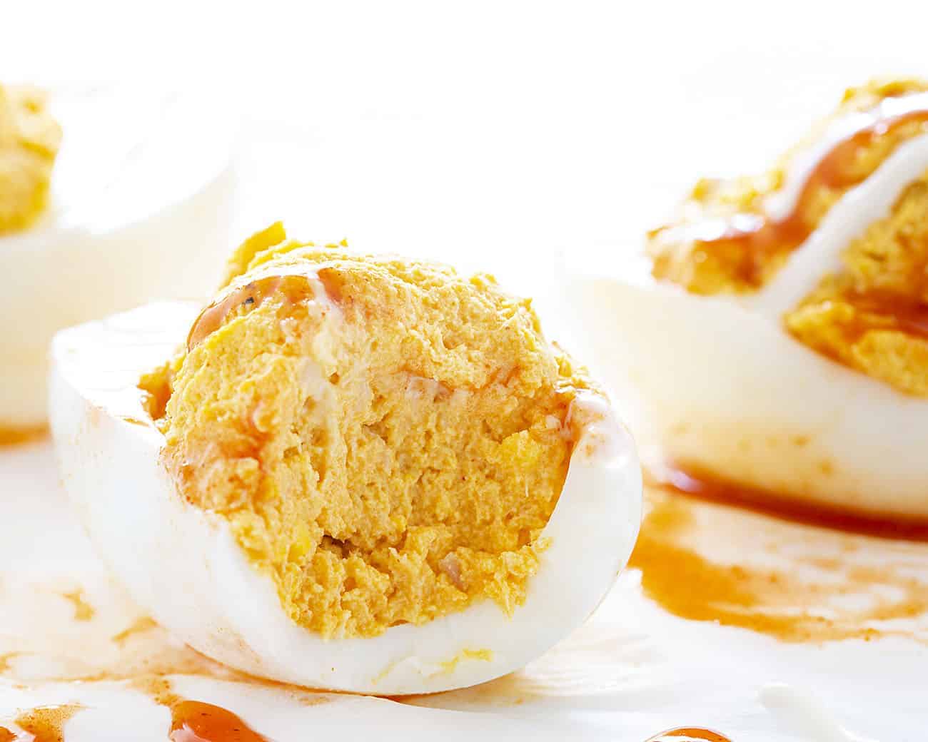 Deviled eggs with a buffalo chicken kick will be your new game day favorite! deviled eggs, buffalo chicken, buffalo chicken deviled eggs, homemade ranch dressing, superbowl appetizer, appetizer, game day appetizer, hard boiled eggs, eggs Bite Taken Out of Buffalo Chicken Deviled Egg