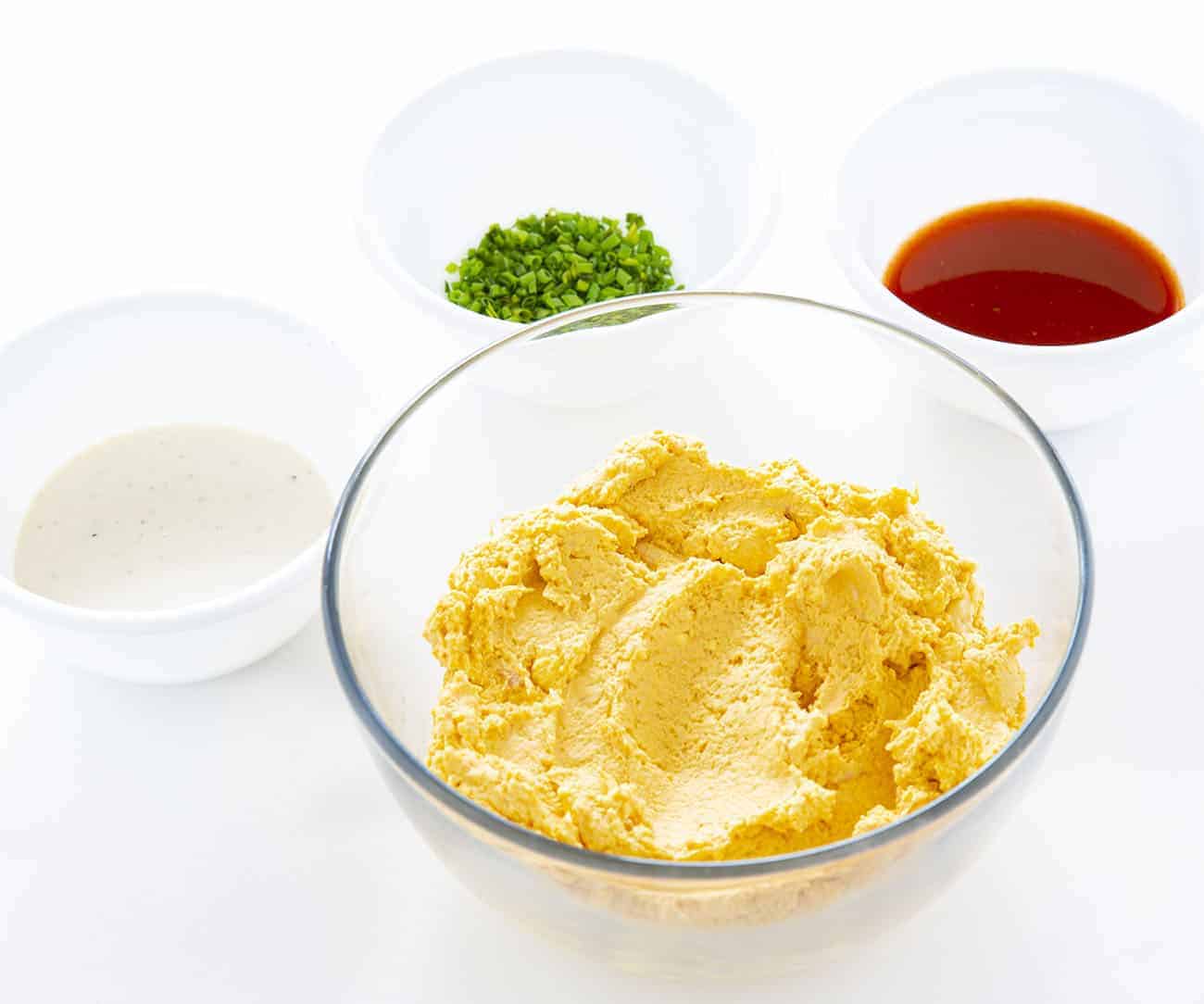Deviled eggs with a buffalo chicken kick will be your new game day favorite! #deviledeggs #buffalochicken #buffalochickendeviledeggs #homemaderanchdressing #superbowlappetizer #appetizer #gamedayappetizer #hardboiledeggs #eggs Filling and Toppings for Buffalo Chicken Deviled Eggs