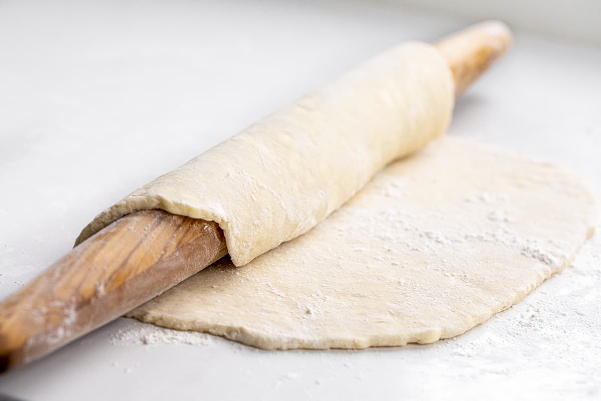 Do you want the best no-fail ALL BUTTER Pie crust? Professional bakers agree, this one tastes the best! Rolling All Butter Pie Dough on a Rolling Pin.