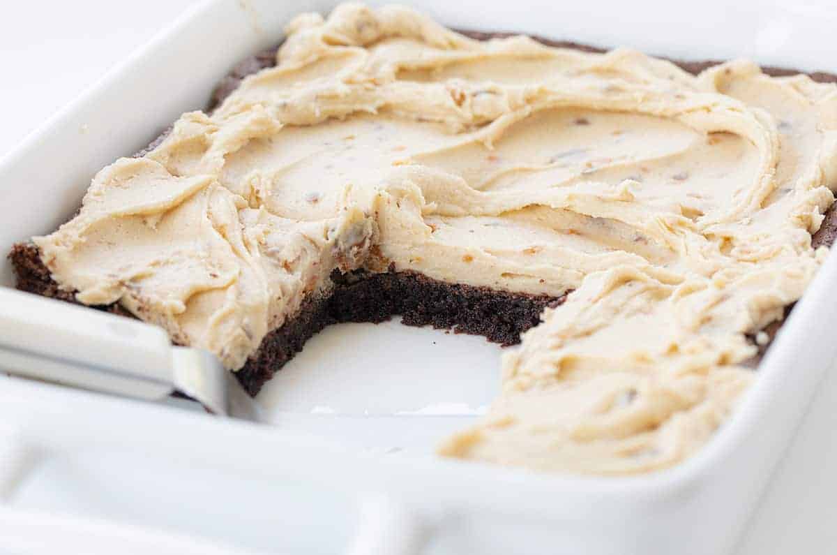Butterfinger Brownies in a White Pan with Pieces Missing