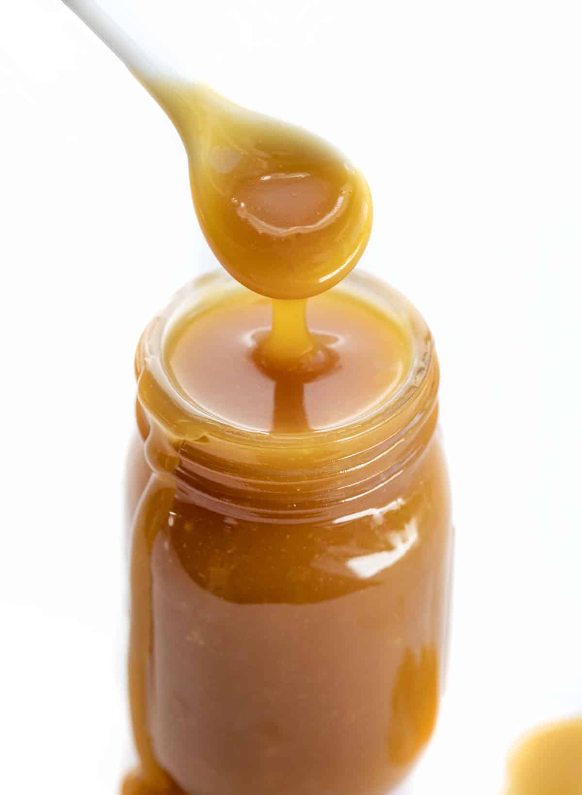 Caramel Sauce is a versatile and flavorful condiment that can be added to many recipes and desserts for added sweetness. Homemade Caramel, Dry Method Caramel, 3 ingredient Caramel, Easy Caramel Sauce, The Best Caramel Sauce, recipes, dessert,i am baker, iambaker Spoon Inside Homemade Caramel Recipe