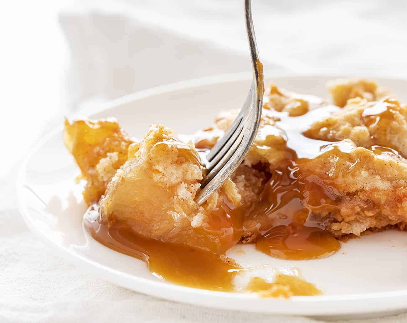 Satisfy everyone's sweet tooth with this Caramel Apple Dump cake--easy to make and to eat, for sure! caramelappledumpcake, caramelapple, desserts, iambaker, dumpcake, baking, thanksgivingdesserts, falldesserts Taking a bite of Caramel Apple Dump Cake
