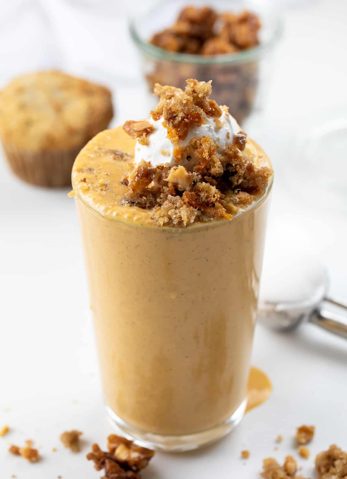 Carrot Cake Milkshake is a delightful and indulgent treat made with classic carrot cake flavors you can taste in each sip! In fact, I even used pieces of carrot cake in the shake. It will surely satisfy your sweet tooth and can be made in just a few minutes. But, there is a SURPRISE INGREDIENT that just might shock you!! Glass of Carrot Cake Milkshake with Whipped Cream and Crumbled Carrot Cake on Top.