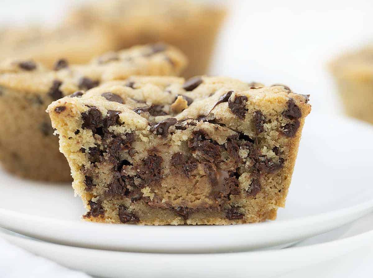 Chocolate Chip Cookie Cups is chocolate chip cookie dough baked in a muffin tin with a surprise mini Reese's Peanut Butter Cup nestled inside! Chocolate Chip Cookie Cups, Mini Chocolate Chip Cookie Cups, Cookie Cups, Cookies in Muffin Pan, Mini Chocolate Chip Cookie Recipe, Chocolate Chip Cookies Stuffed with Reese's, Reese's Chocolate Chip Cookies, Baking, Cookies, Cookie Recipes, CookieCups, i am baker, iambaker Inside of a Chocolate Chip Cookie Stuffed with Mini Reese's Peanut Butter Cup