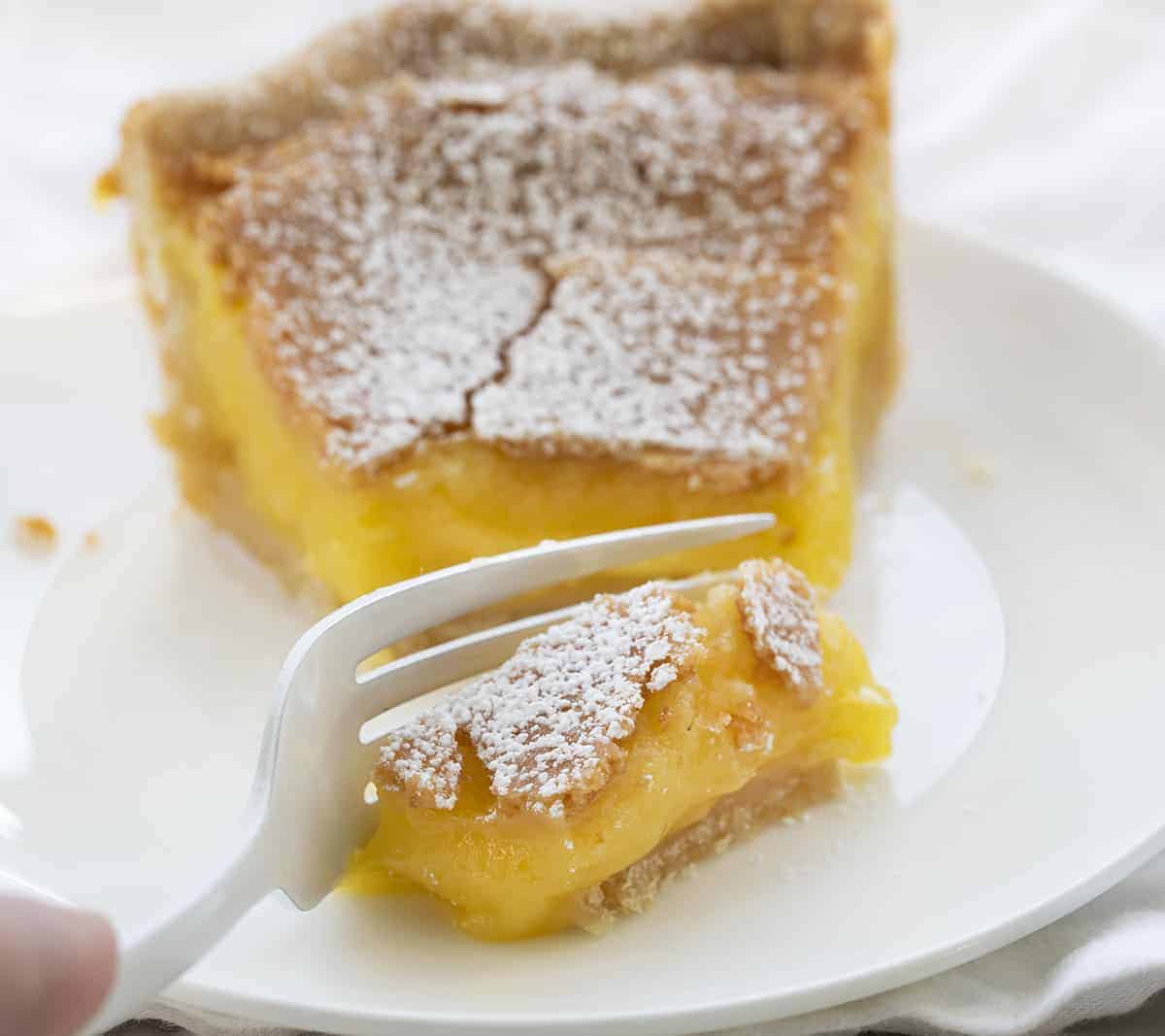 Chess Pie is a rich, sweet, and sugary classic pie that is made with ingredients you probably have on hand and baked in a flaky crust! Pie, Baking, Dessert, Chess Pie, Vintage Dessert, Classic Recipes, Classic Pie Recipes, Homemade Pie Crust, Rustic Pies, i am baker, iambaker Fork Taking a Bite of Chess Pie