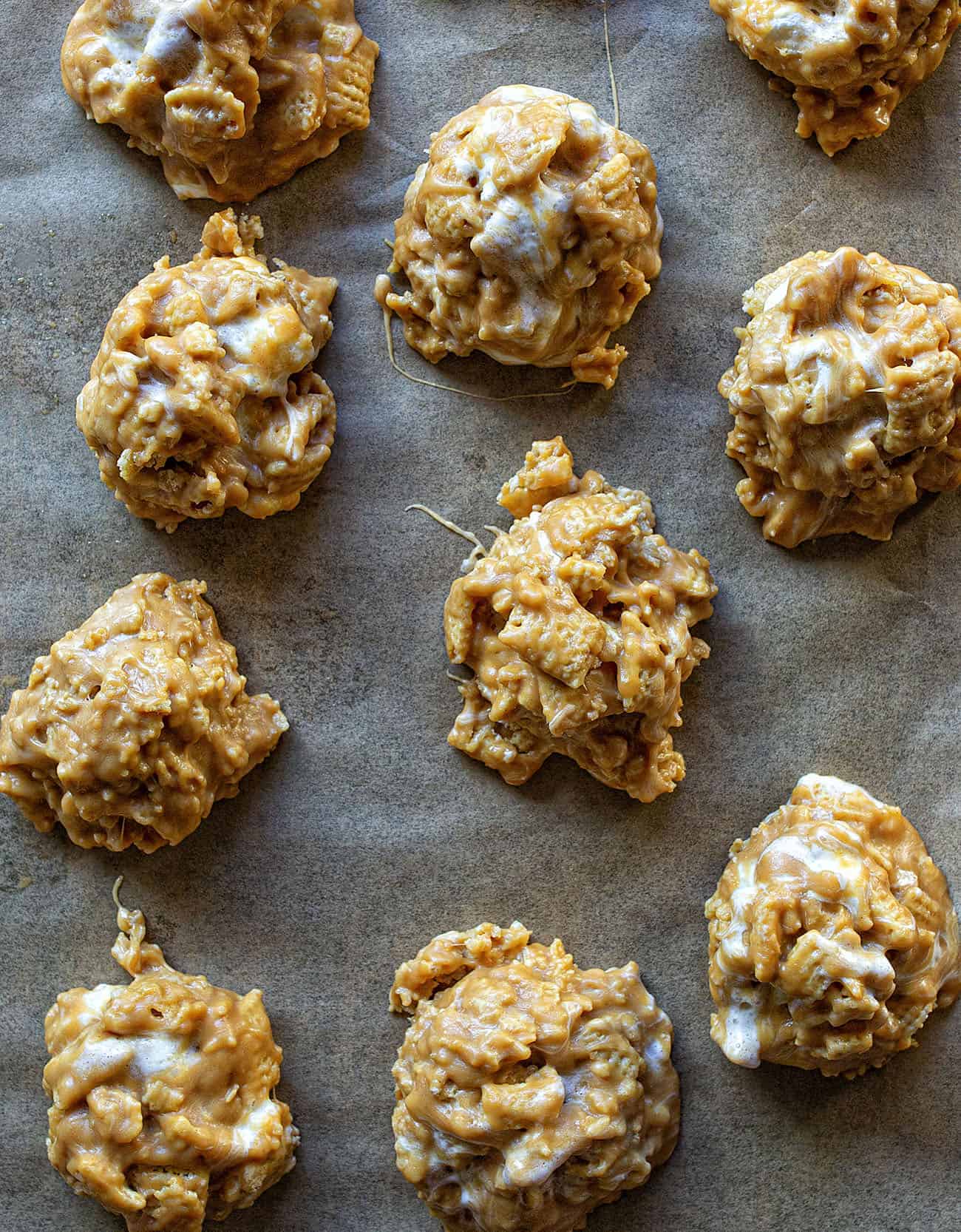 If you want the best sweet snack but don't want to turn on the oven, these are the cookie for you. They basically taste exactly like a special-k bar but are easier to eat! #nobakecookie #nobakedessert #chexcookies #specialkcookies #recipes #cookies #iambaker No-Bake Special K Cookies on a Cookie Sheet