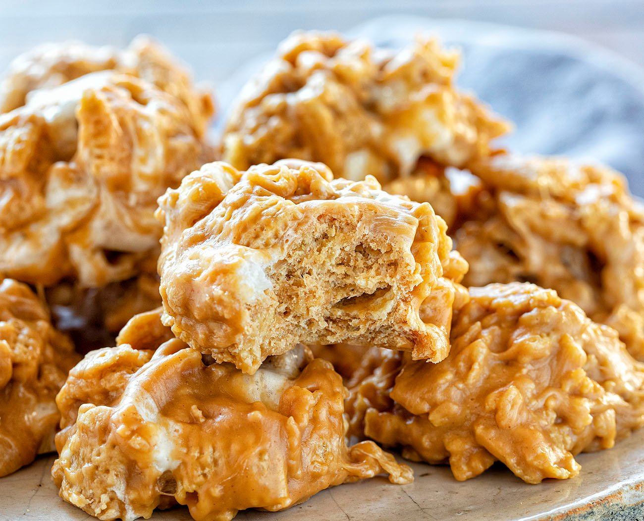 If you want the best sweet snack but don't want to turn on the oven, these are the cookie for you. They basically taste exactly like a special-k bar but are easier to eat! #nobakecookie #nobakedessert #chexcookies #specialkcookies #recipes #cookies #iambaker Bite of a No-Bake Chex Cookie