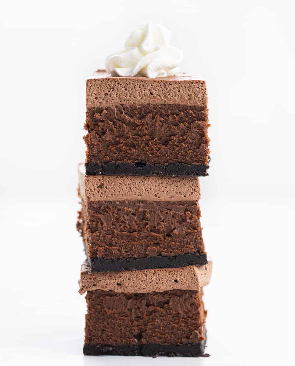 Chocolate Cheesecake Bars are creamy and chocolatey dessert bars with an Oreo cookie crust and homemade chocolate whipped topping. Chocolate Cheesecake, Cheesecake Bars, Chocolate Cheesecake Bars, Chocolate Bars, Triple Chocolate Bars, Dessert, Chocolate Dessert, Baking, i am baker, iambaker, recipes Stacked Chocolate Cheesecake Bars