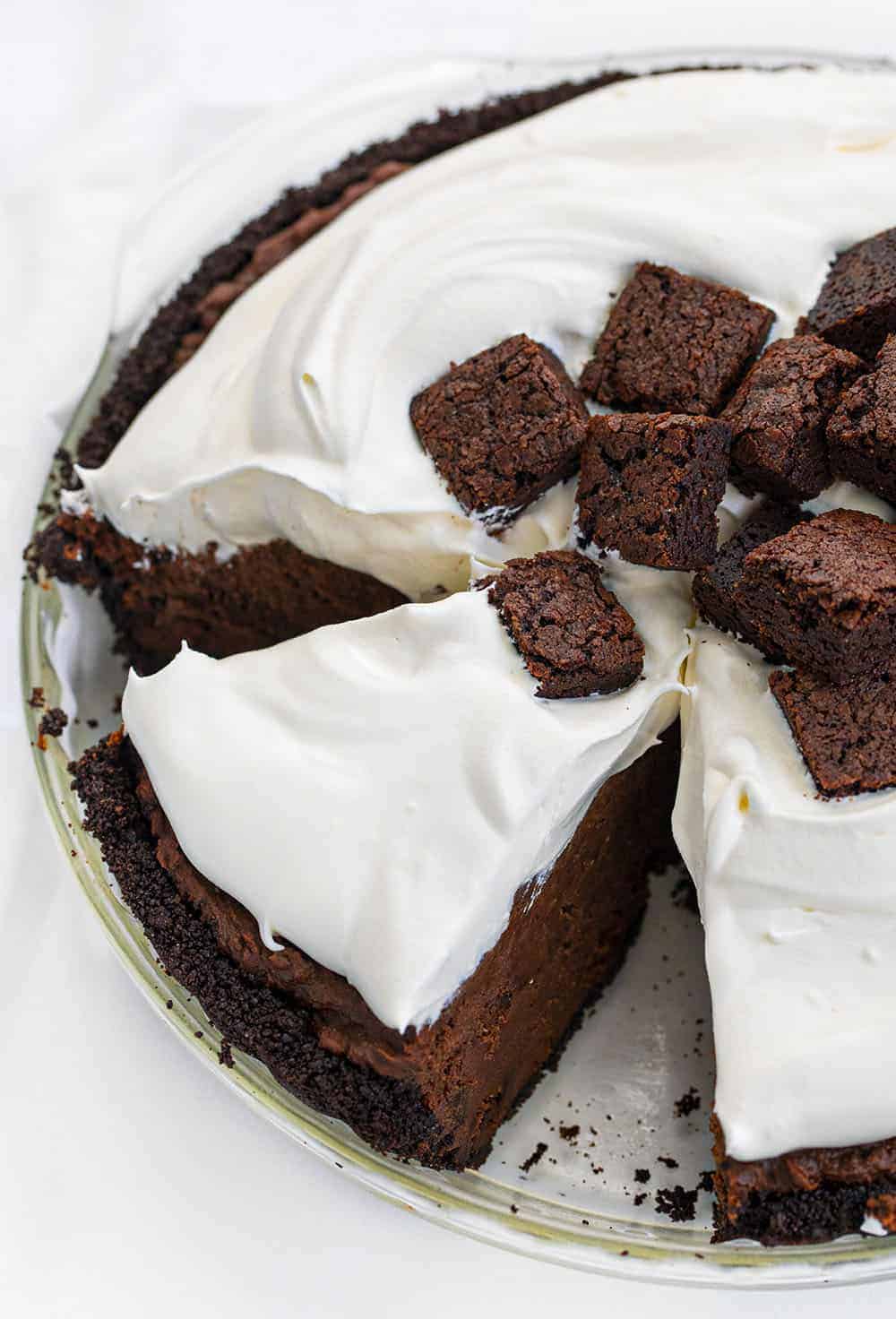 Death By Chocolate Pie is a chocolate lover's dream with its Oreo cookie crust and a creamy chocolate filling loaded with homemade brownie pieces and chocolate whipped cream. Death By Chocolate Pie - Chocolate Brownie Pie, Chocolate Pie, Brownie Pie, Chocolate, Pie, Baking, Brownie Pie, i am baker, Christmas, New Years, i am baker, recipes Death By Chocolate Pie - Chocolate Brownie Pie With Slice Cut Out