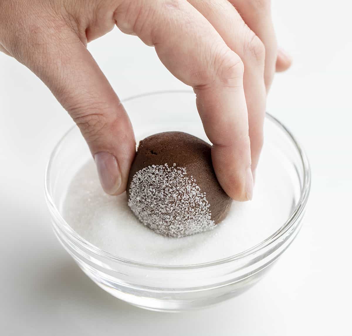Chocolate Sandwich Cookies are soft, chewy, sugary chocolate cookies with a layer of decadent chocolate frosting in between. It's a chocolate lovers dream! Dipping Chocolate Cookie Dough into Granulated Sugar.