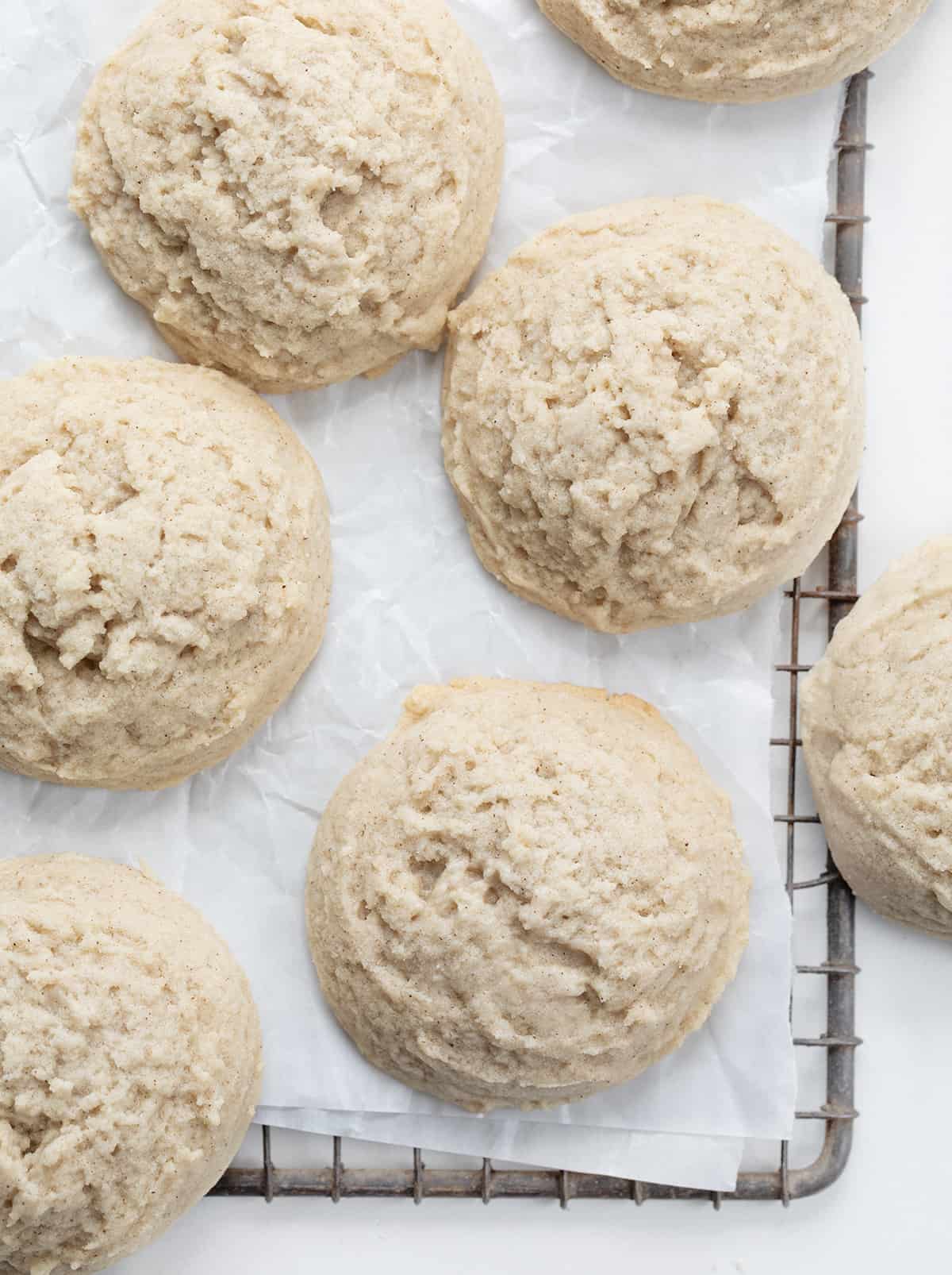 Cinnamon Butter Cookies are tender and crumbly cookies that combine the warm flavor of cinnamon and the richness of butter. The sweet buttery flakiness paired with a subtle cinnamon kick is a delectable combination. It's the perfect addition to any cookie exchange, holiday gathering, or Tuesday! Cinnamon Butter Cookies on a Cooling Rack with Parchment Paper.