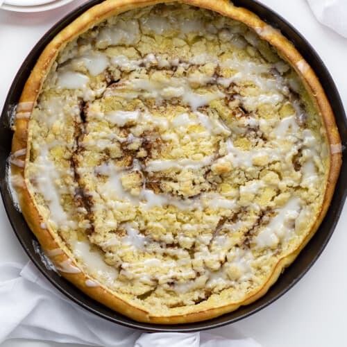 Overhead Image of Cinnamon Sugar Dutch Baby in Skillet on White Counter. Breakfast, Dutch Baby, How to Make Dutch Baby, Easy Breakfast, breakfast recipes, breakfast for guests, i am baker, iambaker.