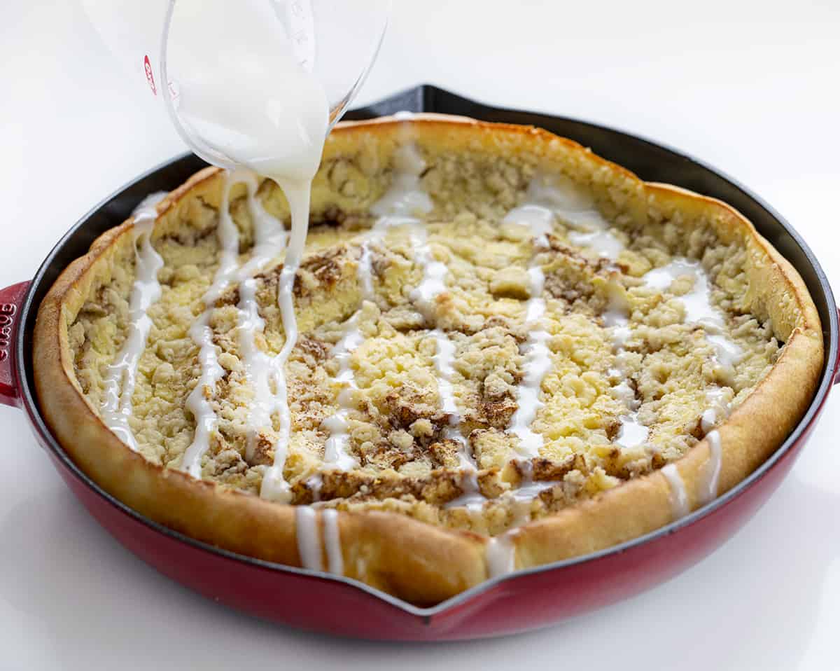 Drizzling Glaze over Cinnamon Sugar Dutch Baby. Breakfast, Dutch Baby, How to Make Dutch Baby, Easy Breakfast, breakfast recipes, breakfast for guests, i am baker, iambaker.