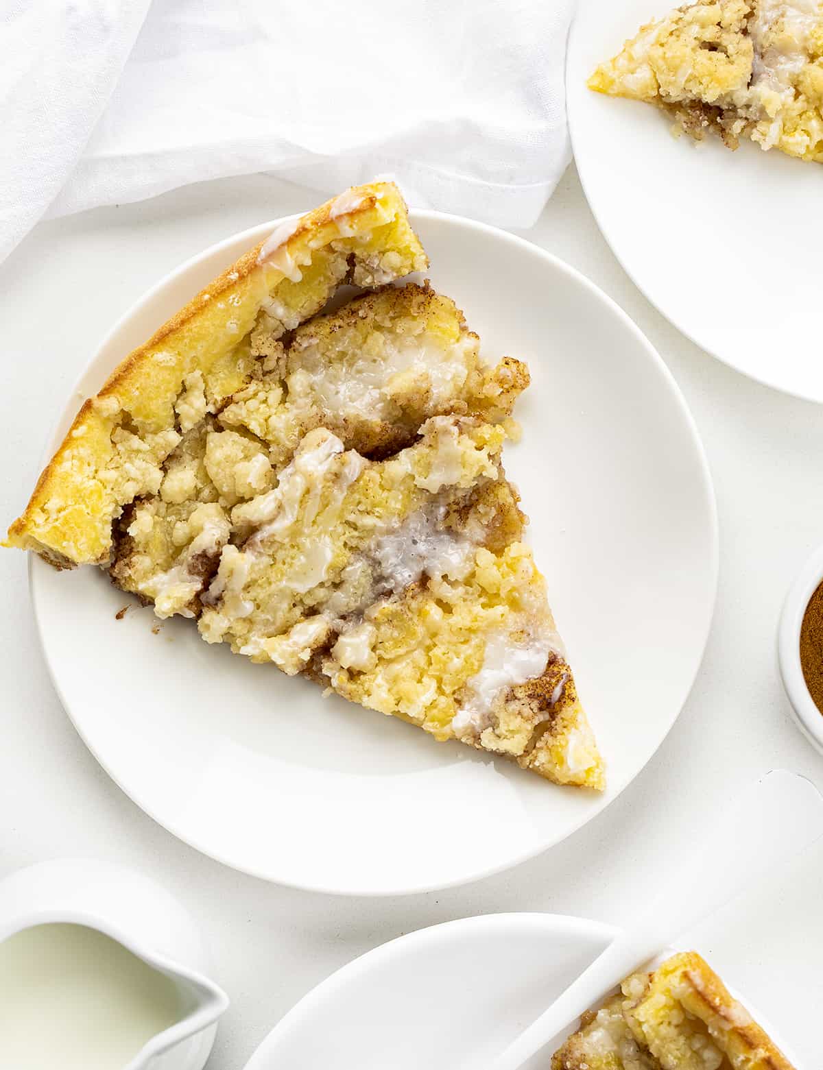 Pieces of Cinnamon Sugar Dutch Baby on White Plates from Overhead. Breakfast, Dutch Baby, How to Make Dutch Baby, Easy Breakfast, breakfast recipes, breakfast for guests, i am baker, iambaker.