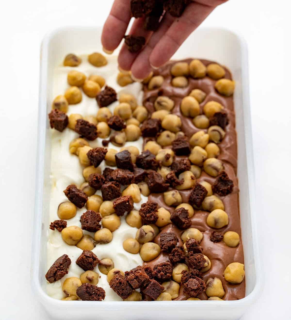 Adding Brownie Bits to Cookie Dough Brownie Ice Cream.