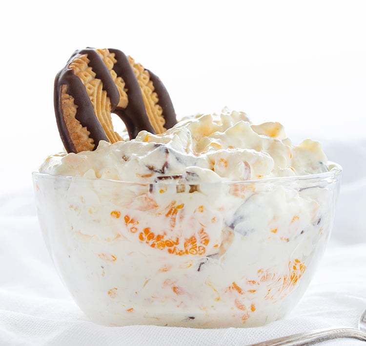 The best no-bake desserts to get your sweet tooth through the summer! no bake, no bake desserts, desserts, recipes, cheesecake, cookies, bars, cake, pudding, mousse, puppy chow, muddie buddies, rice krispy bars, dessert, memorial day dessert, labor day desserts, i am baker, iambaker Bowl of Cookie Salad with Fudge Striped Cookie on Top.