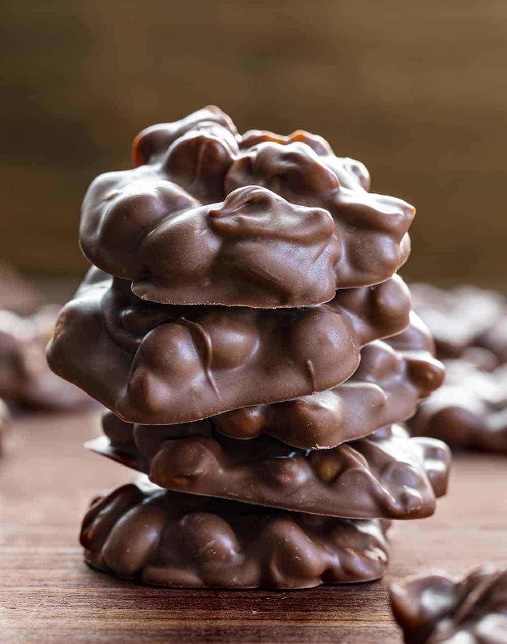 Crockpot Candy is made with two kinds of chocolate, almond bark, peanuts, and peanut butter chips, all melted and blended together in a slow cooker. Crockpot Candy, Chocolate in a Crockpot, Christmas Candy, Valentines Day Candy, Chocolate gifts, chocolate recipes, i am baker, iambaker, candy Stack of Crockpot Candy