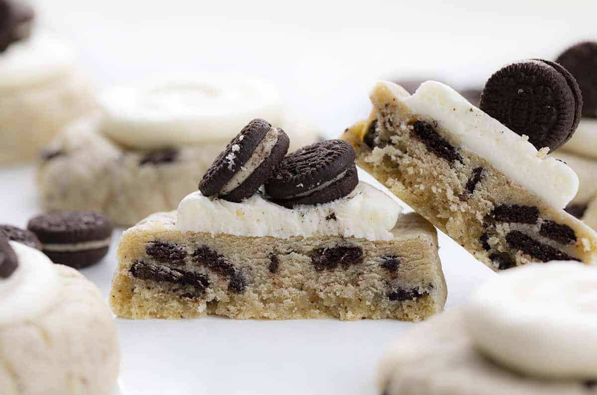 Copycat Crumbl Oreo Cookies are chilled, but super soft cookies that are filled with crushed Oreos and topped with homemade buttercream frosting. Cookies, Baking, Crumbl Cookie Recipe, Copycat Cookies, Frosted Cookies, Oreo Cookies, Dessert, i am baker, iambaker, recipes Cut Into Frosted Cookies and Cream Cookies Recipe - Copycat Crumbl Cookie Recipe