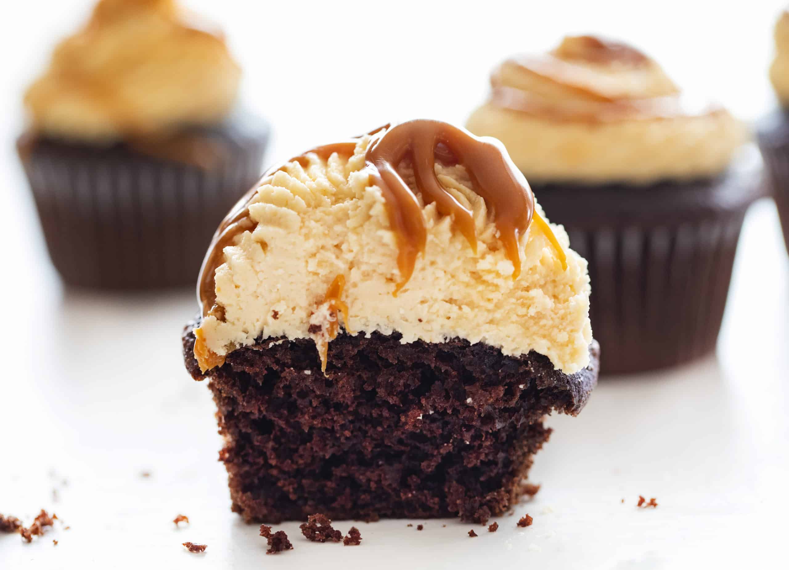 Chocolate Cupcakes with Salted Caramel Buttercream take my Ultimate Chocolate Cupcakes to a whole new salted caramel level! Chocolate Cupcakes, Salted Caramel Buttercream, caramel buttercream, how to make caramel buttercream, chocolate cupcakes, easy chocolate cupcakes, new years eve cupcakes, elegant cupcakes, salted caramel, i am baker Cut into Chocolate Cupcakes with Salted Caramel Buttercream