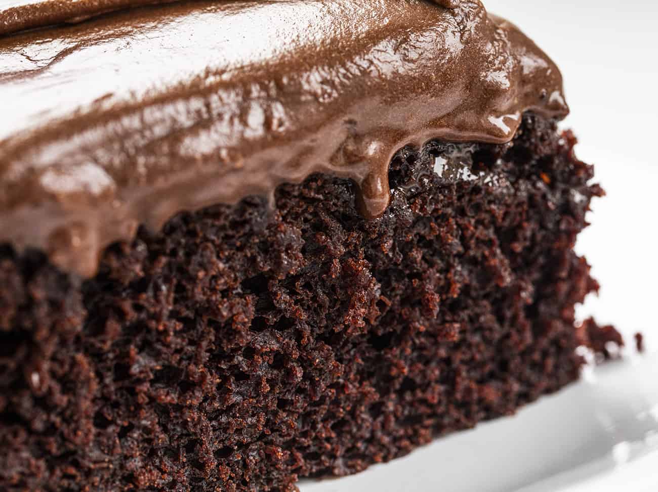 This Chocolate Depression Cake is a moist cake made without any milk, eggs, or butter!! SO DELICIOUS! Depression Cake, Chocolate Depression Cake, Wacky Cake, War Cake, Chocolate Cake, Recipes, Cake, Easy Chocolate Cake, How to Make Chocolate Cake, i am baker, iambaker Close up of Chocolate Depression Cake with Chocolate Frosting Dripping