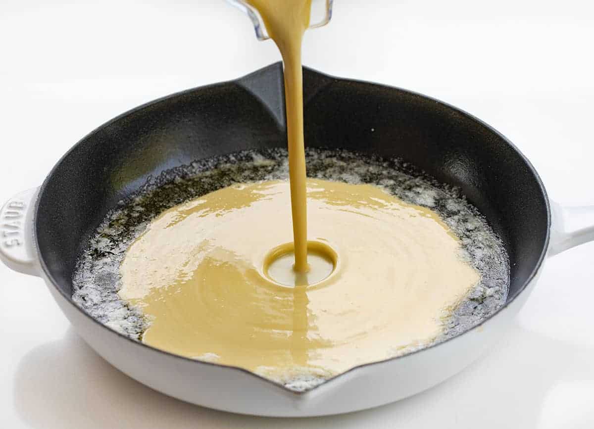 Dutch Baby Pancakes, also known as German or Puff pancakes, is like a combination of a crepe, a pancake, and a popover, all in one. It's a wonderful breakfast or brunch treat. Dutch Baby, German Pancake, Breakfast, recipes, i am baker, iambaker Pouring Dutch Baby Pancake Batter into Hot Pan