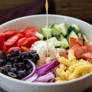 Adding Dressing to Greek Pasta Salad.