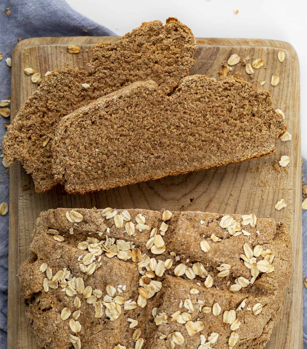 Irish Soda Bread is a dense quick bread that is made with whole wheat flour and bran with old-fashioned oats baked in on top. Irish Soda Bread, How to Make Real Irish Soda Bread, Soda Bread Recipe, Oat Soda Bread, St. Patricks Day, Bread, Recipes, Baking, i am baker, iambaker Cut Into Irish Soda Bread Showing Texture Inside