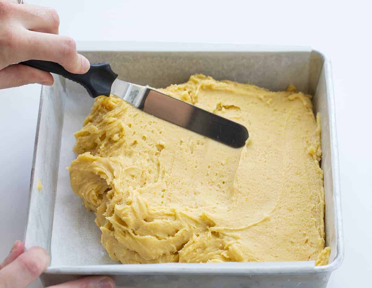 Lemon Brownies are dessert bars that are dense and moist with a lemony flavor and topped with a vanilla glaze. Lemon Brownies, Lemon Blondies, Fudgy Lemon Brownie, The Best Lemon Brownie, Baking, Lemon Recipes, Dessert, i am baker, iambaker Spreading Lemon Brownie Batter Into Pan