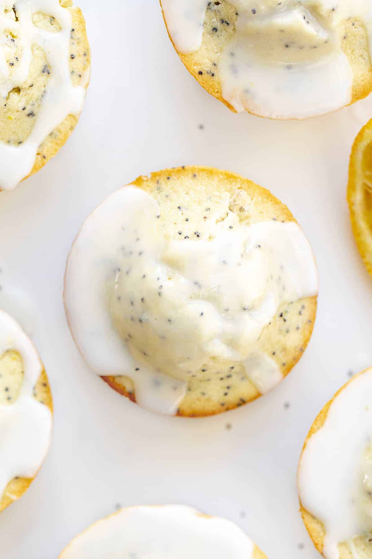 Lemon Poppy Seed Muffins are moist muffins made with lemon juice, lemon zest, and poppy seeds and then topped with a lemon glaze. Muffins, Breakfast, Poppy Seed Muffins, Lemon Poppy Seed, recipes, baking, glaze, i am baker, iambaker Overhead image of Lemon Poppy Seed Muffins with Glaze
