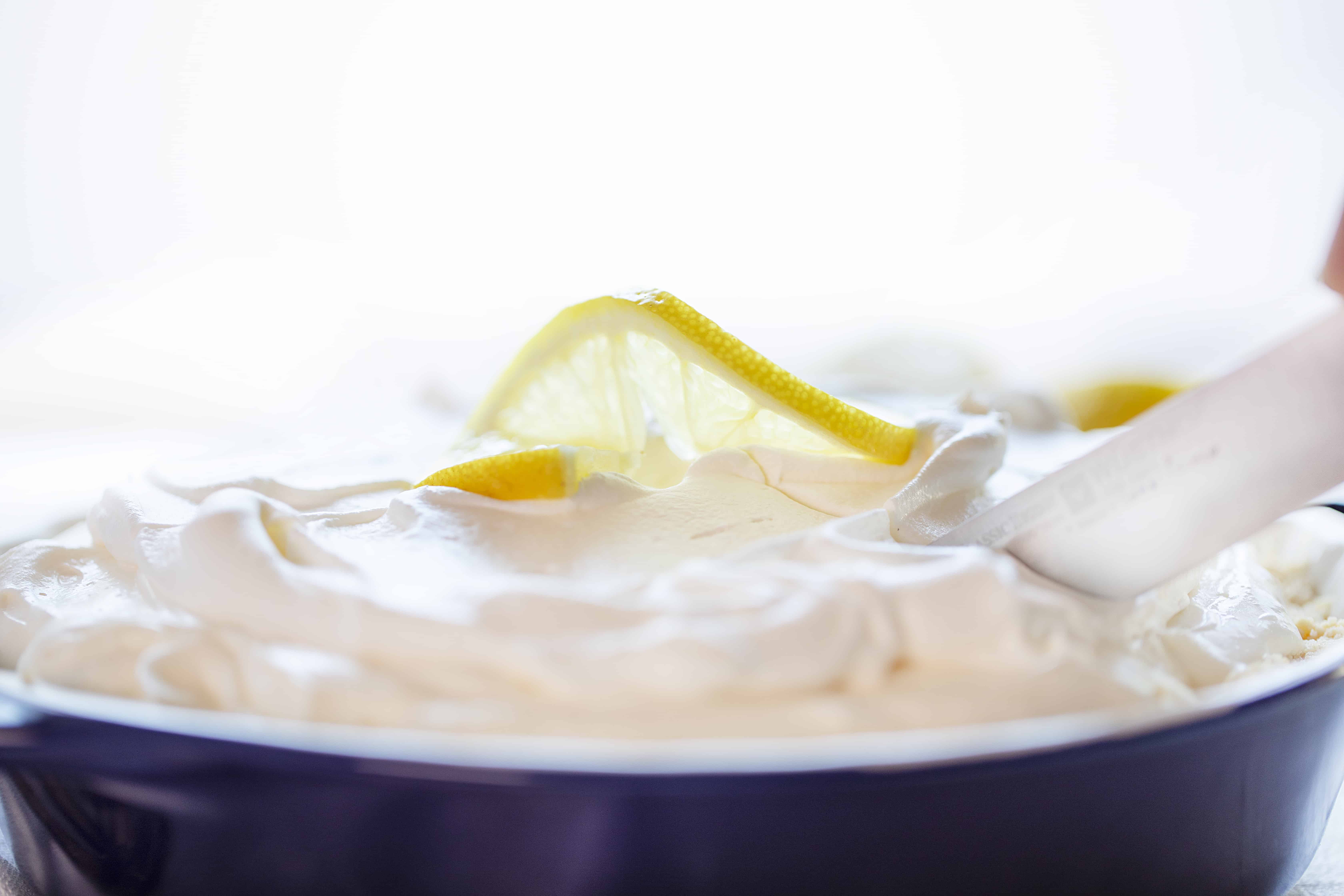 This No Bake Lemon Cream Pie is smooth, velvety, and has the perfect amount of lemon! Super easy to make! #lemoncreampie #lemonpie #nobakedessert #summerdesserts #easydesserts #lemondesserts #iambaker #lemonmousse #nobakepie Whipped Topping on Lemon Cheesecake Cream Pie