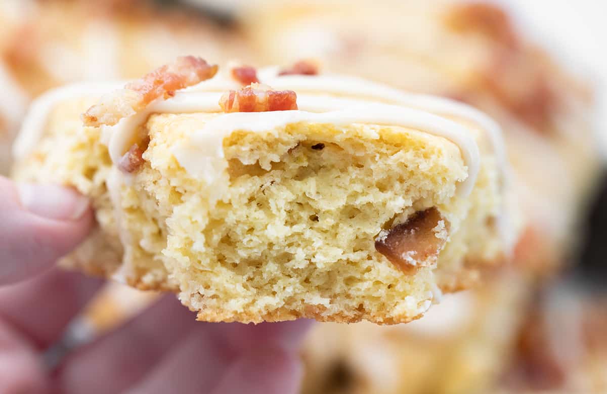 This Maple Bacon Scones recipe is a unique twist on a classic breakfast treat, featuring the perfect blend of sweet maple syrup and salty bacon. The scone has a tender inside and crispy top and is finished with a delicious maple glaze and crumbled bacon. This recipe is easy to follow and uses common ingredients, so don't be intimidated by the thought of making scones! Inside of a Maple Bacon Scone.