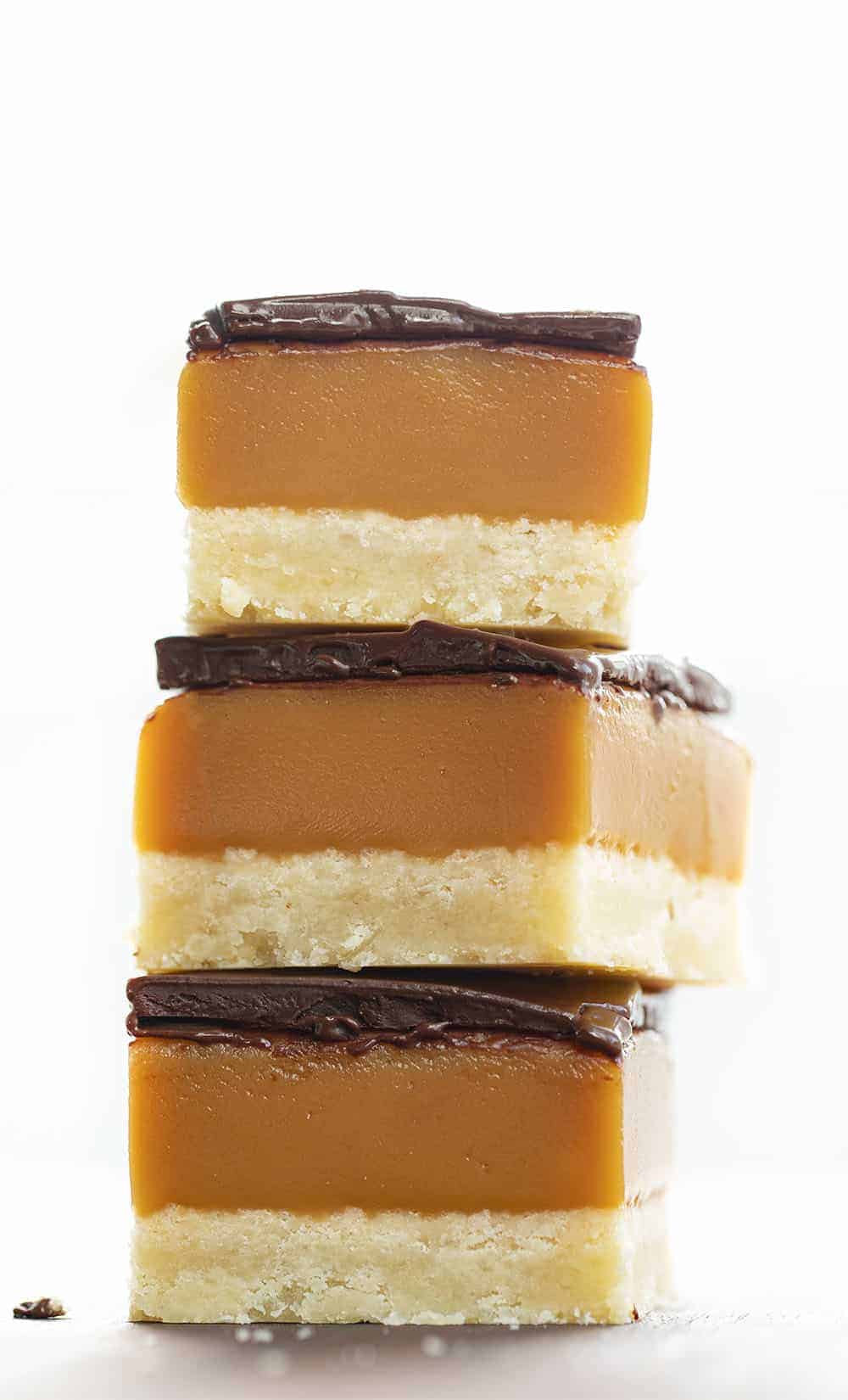 Millionaire's Bars are a sweet, layered dessert made with a shortbread crust, caramel filling, and a semi-sweet chocolate topping. Millionaire Bars, How to Make Millionaire Bars, The Best Millionaire Bars, Billionaire Bars, Bars, Dessert, Recipes, Chocolate, Caramel, Soft Caramel, i am baker, iambaker Millionaires Bars Stacked