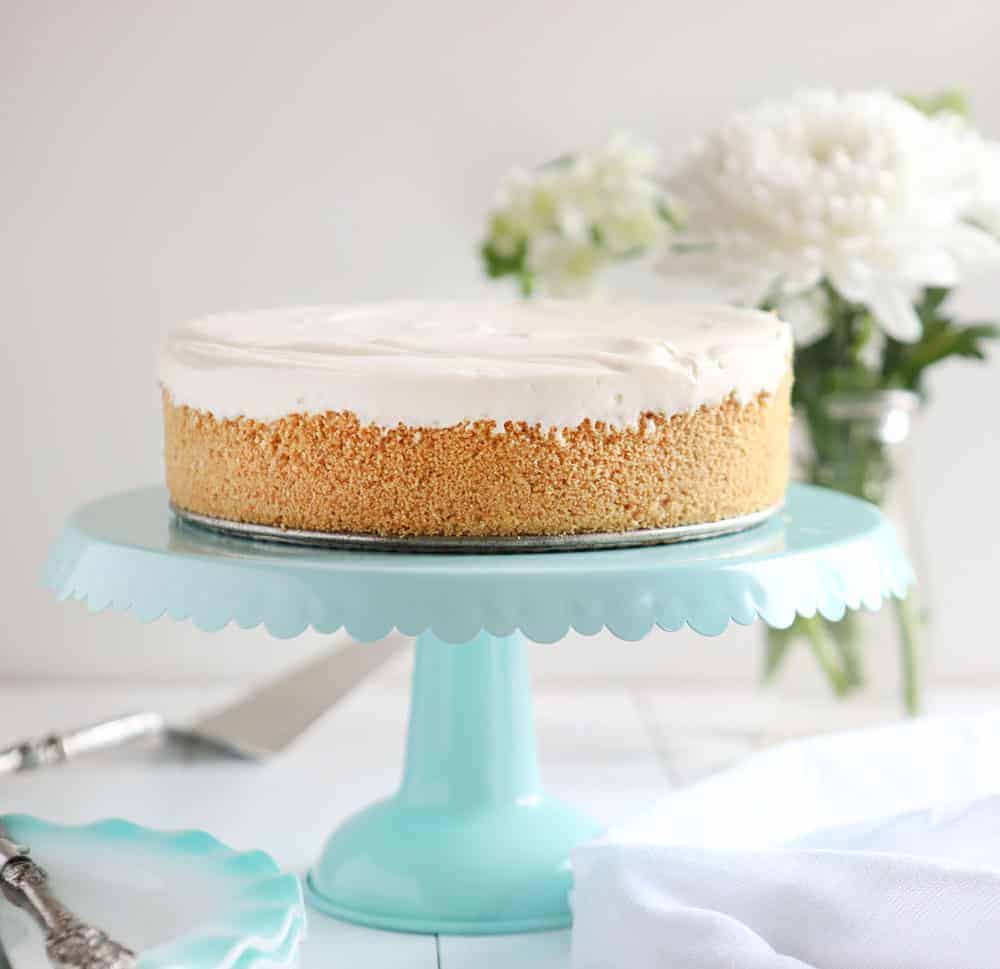 Are you are craving the silky smooth delightfulness that is Cheesecake but don't want to turn on your oven? I have found the perfect No-Bake Cheesecake recipe for you! #nobake #dessert #cheesecake #nobakecheesecake #recipes #cheesecake #iambaker No-Bake Cheesecake on Cake Stand