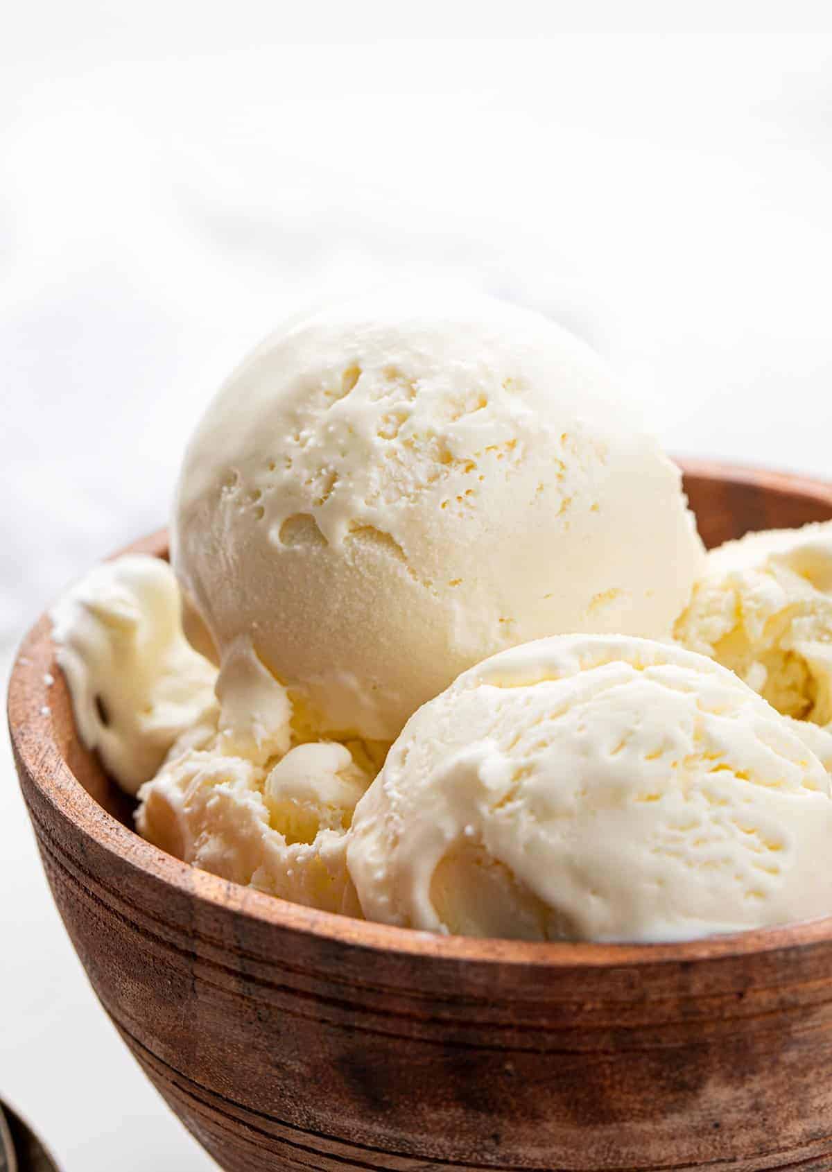 No Churn Vanilla Ice Cream or Four Ingredients Ice Cream. There is no special equipment needed to make this batch of fantastic homemade vanilla ice cream. Ice Cream Recipes, Ice Cream, Vanilla Ice Cream Recipes, How to Make Ice Cream, Food Photography, Ice Cream Food Photography, Homemade Ice Cream with No Machine, dessert, no bake dessert, BBQ Dessert, Cookout Dessert, i am baker, iambaker No Churn Ice Cream Scoops in a Wooden Bowl