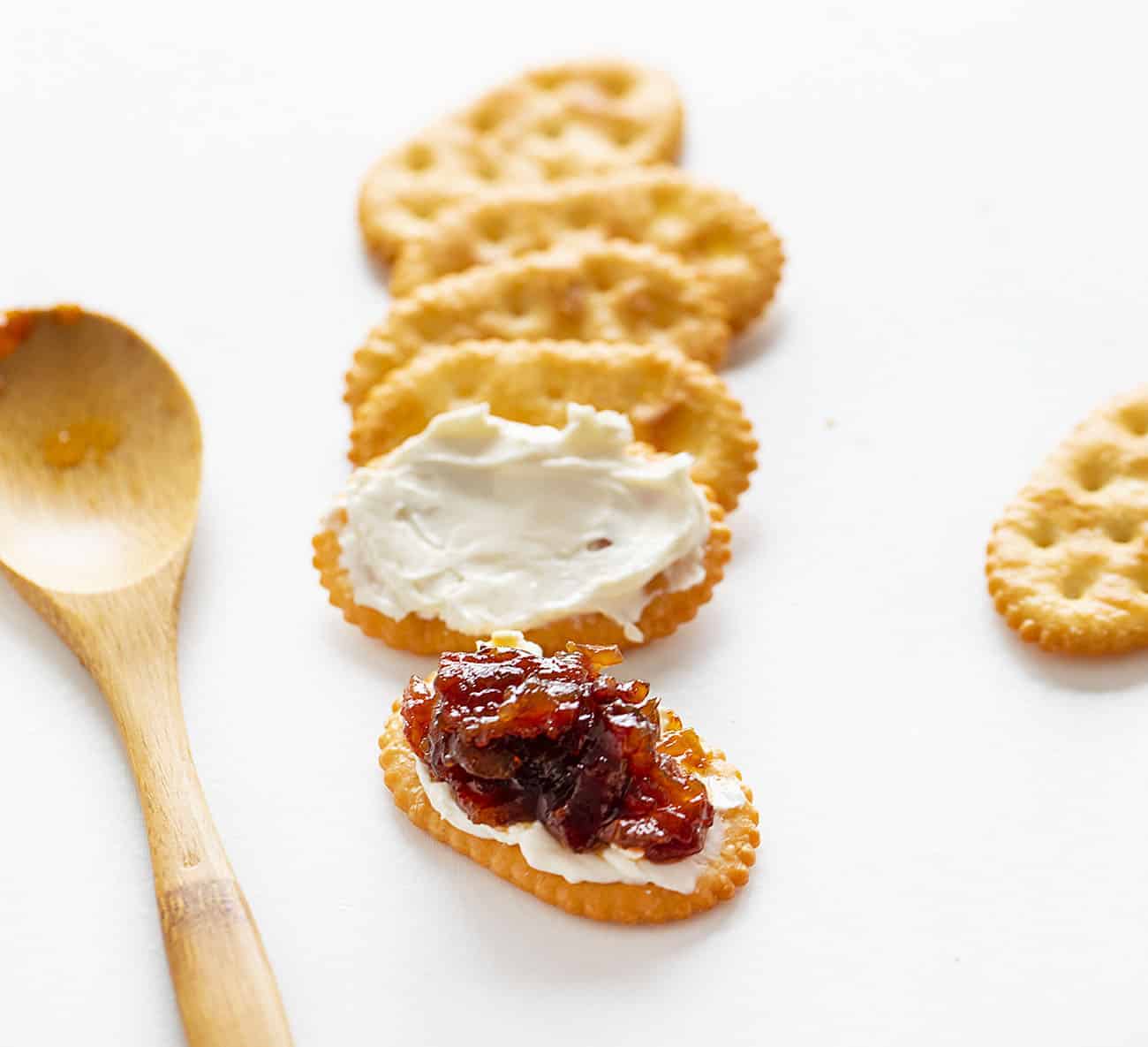 This Onion Bacon Jam recipe is literally the best in the world. I know that's a big statement, but I've been told that so many times that I have to believe it! Bacon Jam, Onion Bacon Jam, How to Make Bacon Jam, How to Make Onion Bacon Jam, Onion Bacon Jam Recipe, Bacon Jam Recipe, Appetizer, holiday appetizer, make ahead appetizer, easy appetizer, i am baker Onion Bacon Jam on a Cracker with Cream Cheese