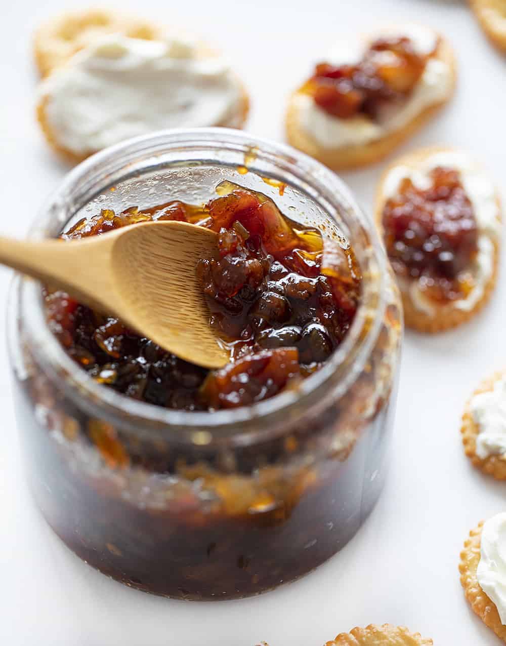 This Onion Bacon Jam recipe is literally the best in the world. I know that's a big statement, but I've been told that so many times that I have to believe it! Bacon Jam, Onion Bacon Jam, How to Make Bacon Jam, How to Make Onion Bacon Jam, Onion Bacon Jam Recipe, Bacon Jam Recipe, Appetizer, holiday appetizer, make ahead appetizer, easy appetizer, i am baker Onion Bacon Jam in a Jar with a Spoon