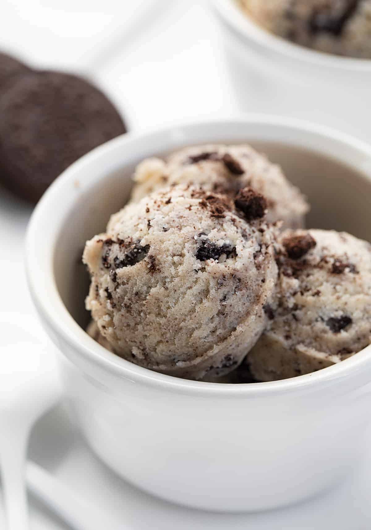 Oreo Cookie Dough is a sweet treat made without eggs that you can indulge in by the spoonful! Cookie Dough, Cookie Dough Recipes, how to make Oreo cookie dough, eggless cookie dough, easy cookie dough, dessert, easy dessert, game day dessert, game day treats, game day recipes, easy oreo recipes, no bake desserts, i am baker, iambaker Oreo Cookie Dough Scooped into a Cup