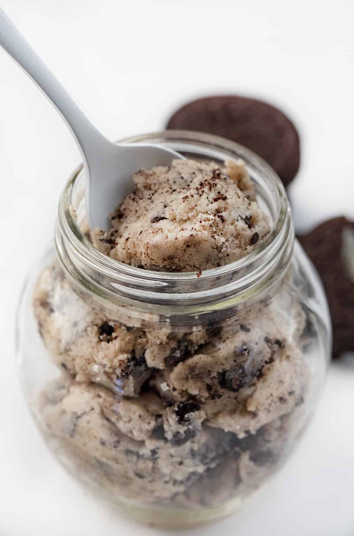 Oreo Cookie Dough is a sweet treat made without eggs that you can indulge in by the spoonful! Cookie Dough, Cookie Dough Recipes, how to make Oreo cookie dough, eggless cookie dough, easy cookie dough, dessert, easy dessert, game day dessert, game day treats, game day recipes, easy oreo recipes, no bake desserts, i am baker, iambaker Spoon taking bite of Oreo Cookie Dough