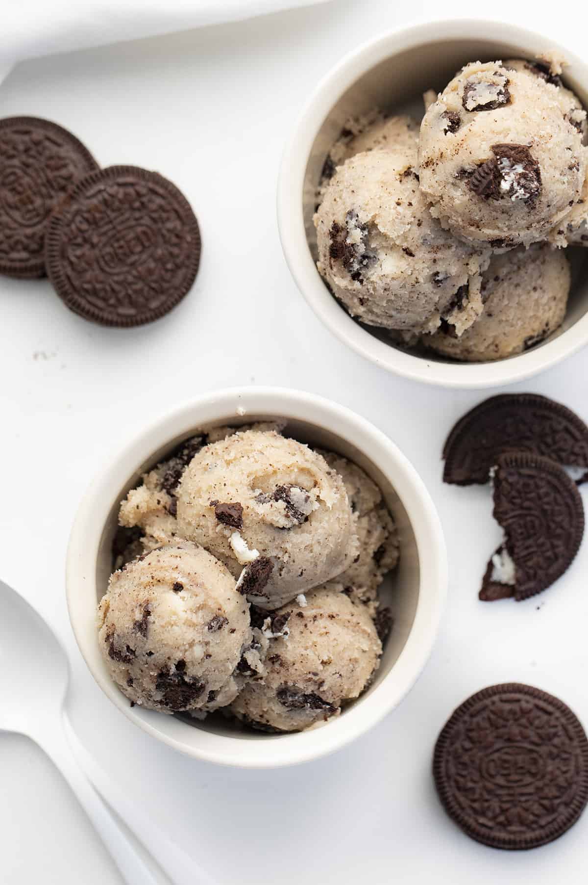 Oreo Cookie Dough is a sweet treat made without eggs that you can indulge in by the spoonful! Cookie Dough, Cookie Dough Recipes, how to make Oreo cookie dough, eggless cookie dough, easy cookie dough, dessert, easy dessert, game day dessert, game day treats, game day recipes, easy oreo recipes, no bake desserts, i am baker, iambaker Bowls of Oreo Cookie Dough with Oreos and Spoons