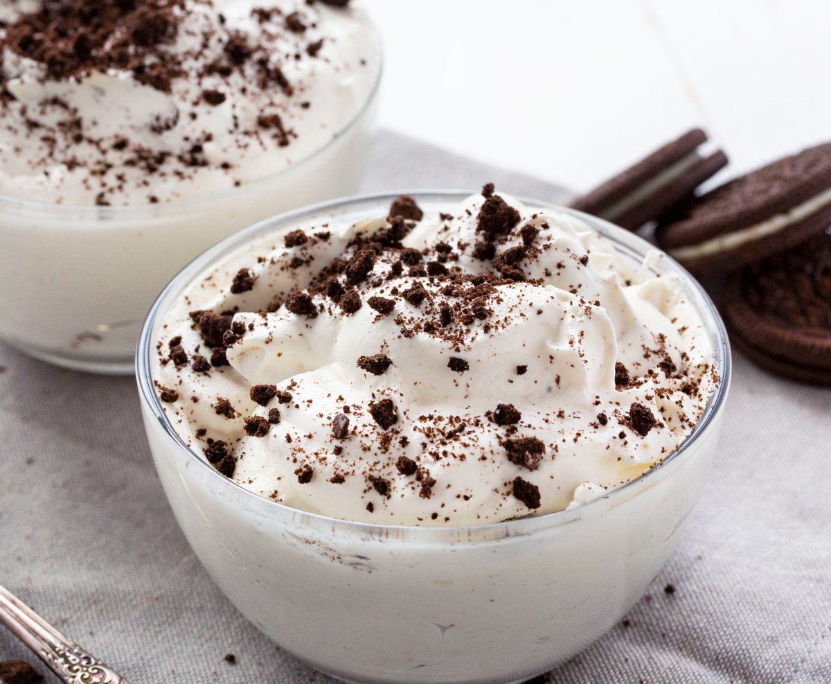 The best no-bake desserts to get your sweet tooth through the summer! no bake, no bake desserts, desserts, recipes, cheesecake, cookies, bars, cake, pudding, mousse, puppy chow, muddie buddies, rice krispy bars, dessert, memorial day dessert, labor day desserts, i am baker, iambaker Oreo Fluff in a Glass Bowl Topped with Oreos.