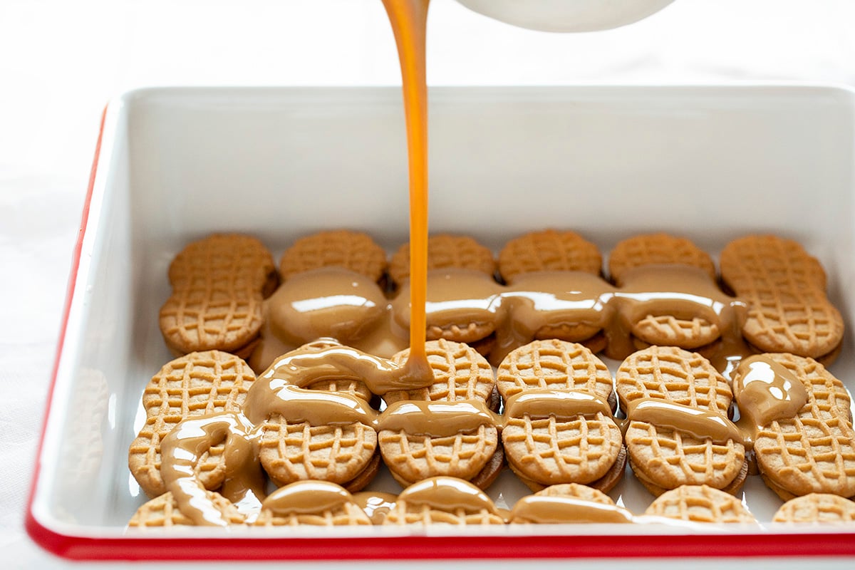 The best no-bake desserts to get your sweet tooth through the summer! no bake, no bake desserts, desserts, recipes, cheesecake, cookies, bars, cake, pudding, mousse, puppy chow, muddie buddies, rice krispy bars, dessert, memorial day dessert, labor day desserts, i am baker, iambaker Peanut Butter Cookie Dessert Starting with first Layer where Peanut Butter is Poured Over Nutter Butters.