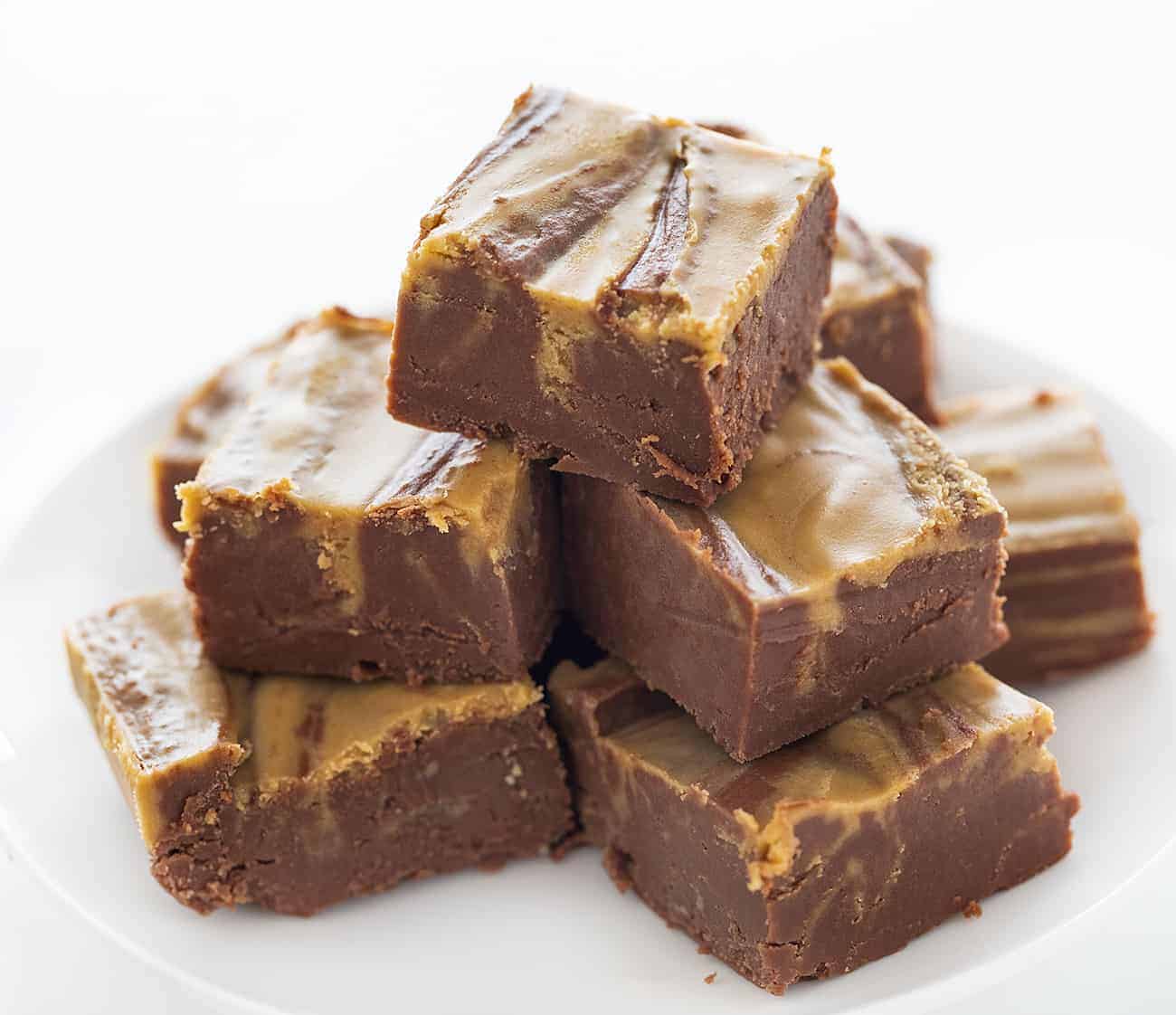 Chocolate Peanut Butter Fudge is the perfect pairing of chocolate and peanut butter! How to Make Fudge, How to Make Chocolate Peanut Butter Fudge, easy chocolate peanut butter fudge, peanut butter fudge, chocolate fudge, how to make fudge correctly, fantasy fudge, fudge recipes, entertaining, sweets, dessert, snacks, real fudge, i am baker Stacked Chocolate Peanut Butter Fudge on a White Plate