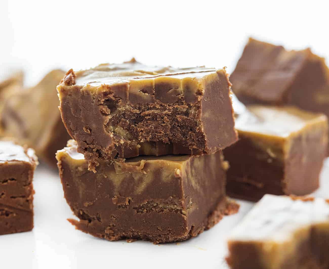 Chocolate Peanut Butter Fudge is the perfect pairing of chocolate and peanut butter! How to Make Fudge, How to Make Chocolate Peanut Butter Fudge, easy chocolate peanut butter fudge, peanut butter fudge, chocolate fudge, how to make fudge correctly, fantasy fudge, fudge recipes, entertaining, sweets, dessert, snacks, real fudge, i am baker Piece of Chocolate Peanut Butter Fudge bit into