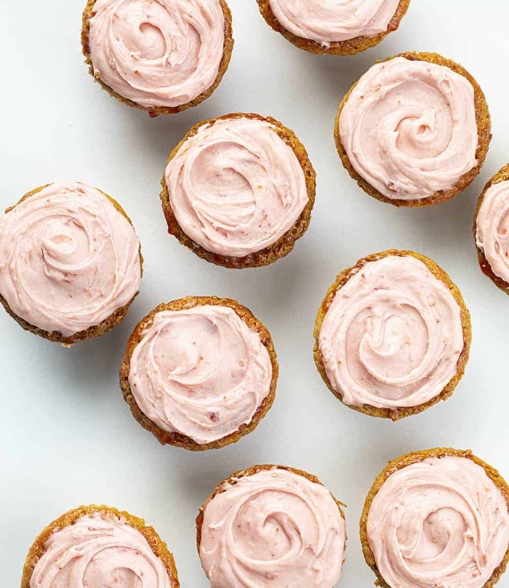 Peanut Butter and Jelly Cupcakes are peanut butter cupcakes topped with a strawberry glaze and covered in sweet, strawberry frosting. PB&J Cupcakes, Peanut Butter Cupcakes, Peanut Butter and Jelly Cupcakes, Jelly frosting, jam frosting, peanut butter & jelly recipes, cupcakes, cupcake recipes, baking, dessert, snacks, popular kids cupcake, i am baker, iambaker, recipes Overhead view of Peanut Butter and Jelly Cupcakes